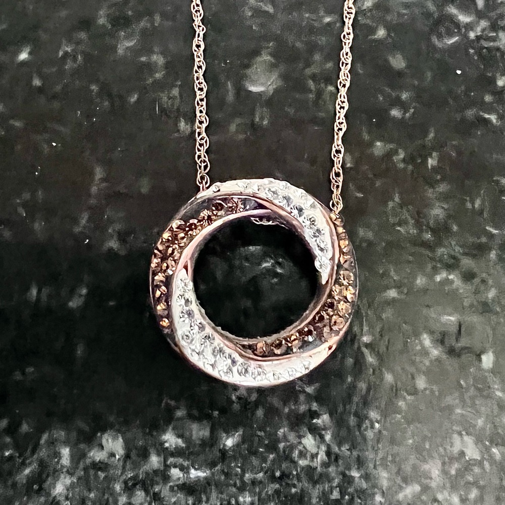 Cubic zirconia and copper unique charm on 18-inch chain.